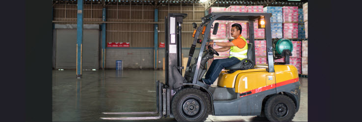 male worker driving a forklift