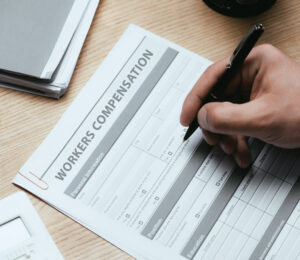 man filling out workers compensation claim form