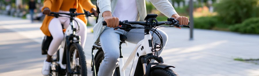two people riding ebikes