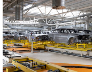cars on conveyor belt in auto plant